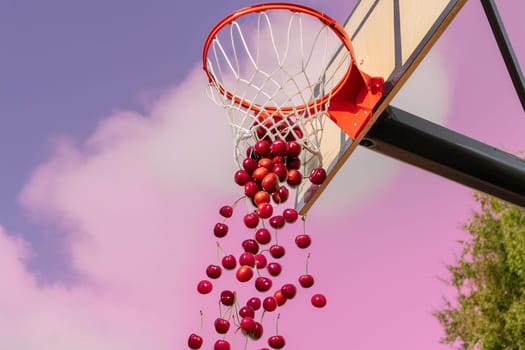 Cherries scoring in basketball hoop against pink sky.