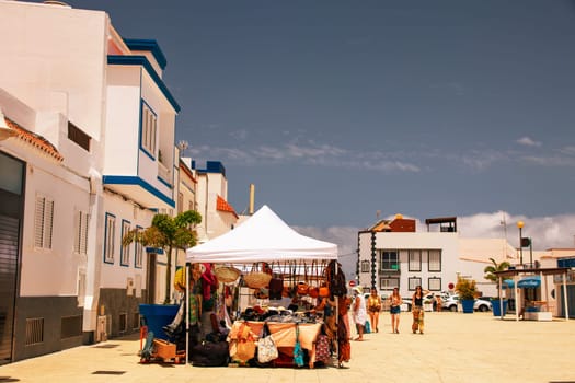 Puerto de las Nieves, island of Gran Canaria, Spain – 20 Jul 2024. Tourists and locals on the streets with typical white-blue romantic architecture port town.