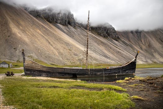 Old wooden viking boat stranded on  fjord in iceland
