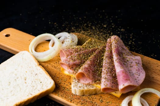 Slices of sausage Mortadella and onion on a cutting board