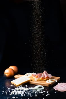 Slices of sausage Mortadella and onion on a cutting board