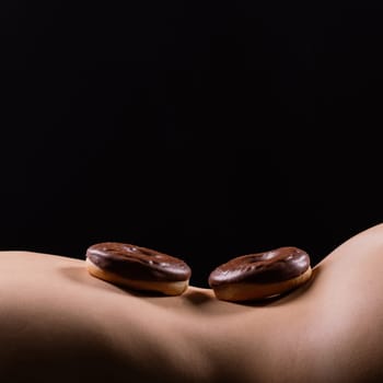 Plus size seductive model female, fashionable blonde in a black bodysuit with donut