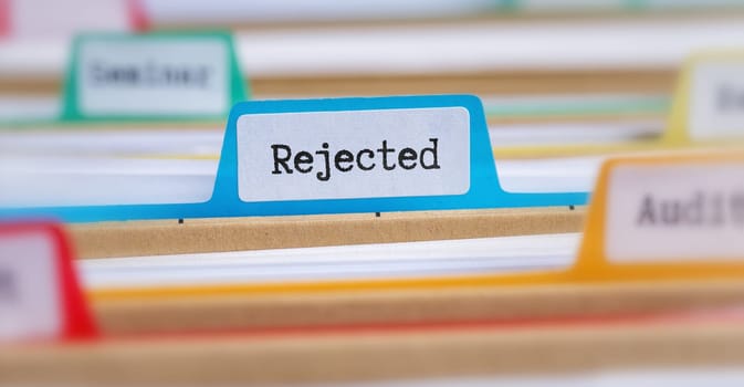 File folders with a tab labeled Rejected