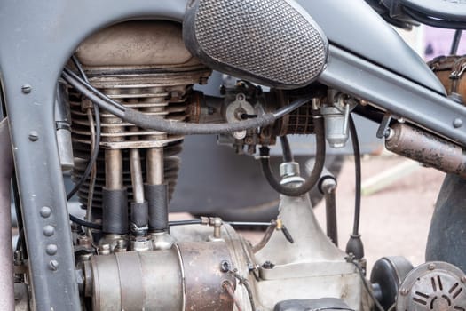 A motorcycle engine is old and rusty