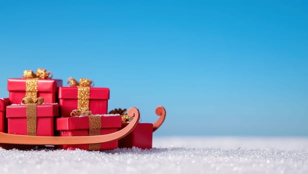 Red Christmas sleigh with gifts on snow against blue background. Christmas, winter holidays, delivery concept.