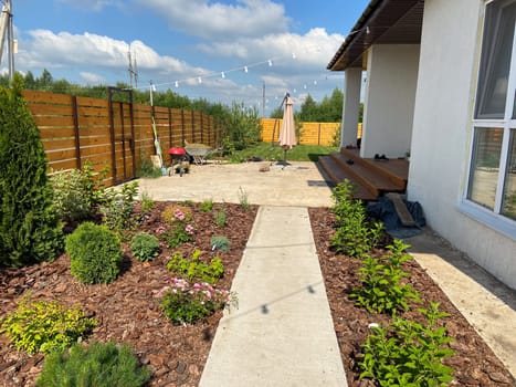 Freshly planted flower bed in the garden with a variety of flowers and plants in spring time.