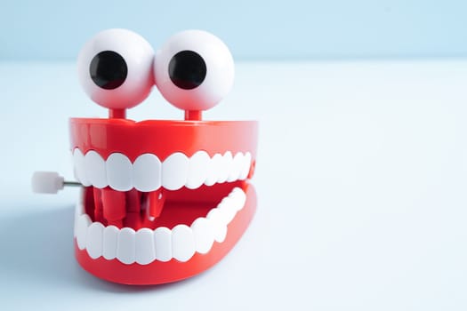 Funny red teeth with eye toy denture model for dental health care.