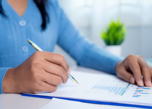 Businesswoman show paper documents to analyze business and manage corporate data, Business analytics with charts KPIs to improve organizational performance, Marketing and financial strategy.