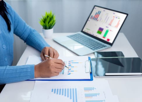 Businesswoman show paper documents to analyze business and manage corporate data, Business analytics with charts KPIs to improve organizational performance, Marketing and financial strategy.