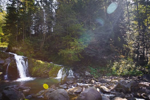 Very beautiful waterfall in autumn in the forest. Ukraine, Carpathians.