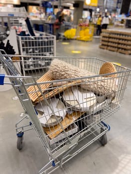 A shopping cart filled with various items in shop.