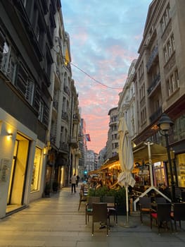 BELGRADE, SERBIA - NOVEMBER 11, 2022: Kneza Mihailova street at dawn, crowded. Also known as Knez Mihaila, this is the main pedestrian street of the city, and the main touristic attraction.