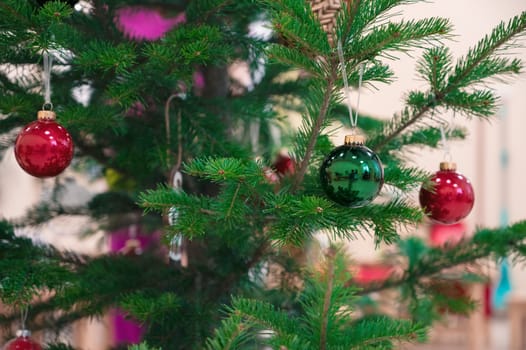 Christmas fir tree adorned with baubles in close up