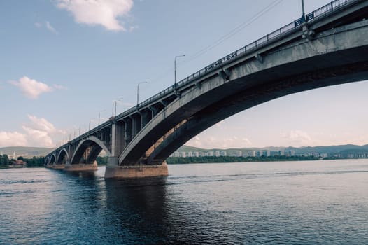 Communal bridge over the Yenisei River at beauty sunny summer day in Krasnoyarsk city.