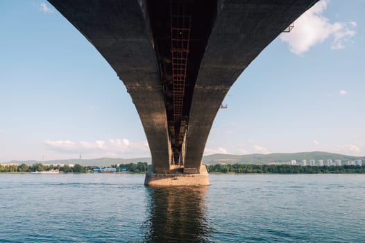 Communal bridge over the Yenisei River at beauty sunny summer day in Krasnoyarsk city.