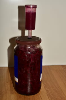 Fermentation of beetroot in a glass with fermentation valve