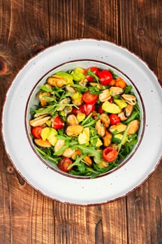 Plate showcasing mussel salad with fresh vegetables.