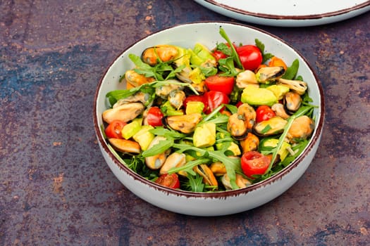 Plate showcasing mussel salad with fresh vegetables.