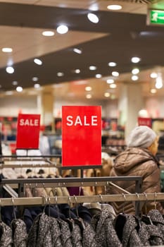 Sign with the inscription Sale to indicate a special offer in a clothing store