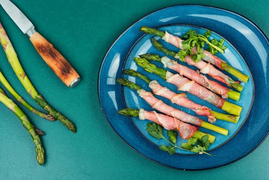 Young green asparagus baked in bacon. Top view.