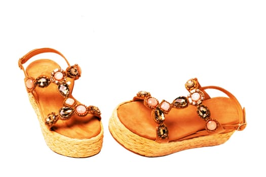 Leather shoes isolated. Close-up of a single of elegant female suede sandals with rhinestones. Isolated on white background. Macro.
