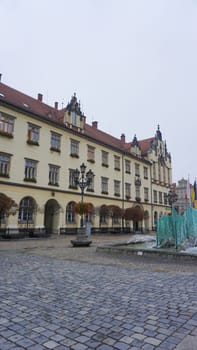 Wroclaw, Poland - April 17, 2022: The old town hall building with a clock in the center of Wroclaw Square at Poland