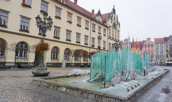 Wroclaw, Poland - April 17, 2022: The old town hall building with a clock in the center of Wroclaw Square at Poland