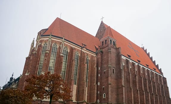 The St Elizabeth Church is hidden behind the houses of old Odrzanska street located next to the Market Square in Wroclaw.