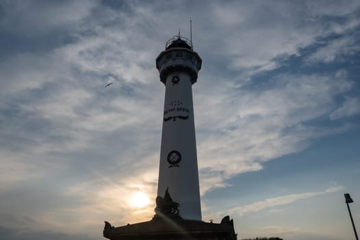 The approx. 28 m high white lighthouse J.C.J. van Speijk in Egmond aan Zee, North Holland, Netherlands at sunset