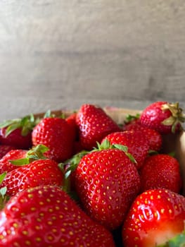 Vibrant collection of fresh strawberries fills the frame, showcasing their bright red hue and inviting texture. Close-up captures the essence of natural sweetness and summer abundance.