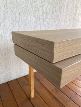 Stacked wooden planks display an exquisite blend of natural texture and modern design. Warm tones and linear grain pattern bring elegance and simplicity to this architectural detail.