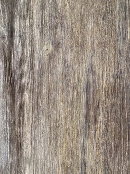 Rustic wooden panel leans gracefully against a textured, showcasing its rich grain patterns and natural warmth.