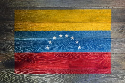 A Venezuela flag on rustic old wood surface background