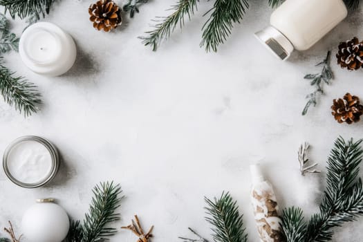 A tranquil winter spa setting featuring candles skincare products and pine branches arranged on a soft snowy surface.