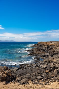 Rocky coastline at Playa Blanca with a view of the beautiful blue Atlantic Ocean on Lanzarote