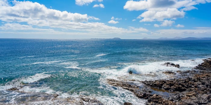 Rocky coastline at Playa Blanca with a view of the beautiful blue Atlantic Ocean on Lanzarote