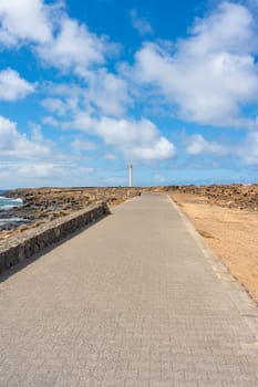 Coast along the promenade to the Faro de Punta Pechiguera lighthouse at Playa Blanca on Lanzarote