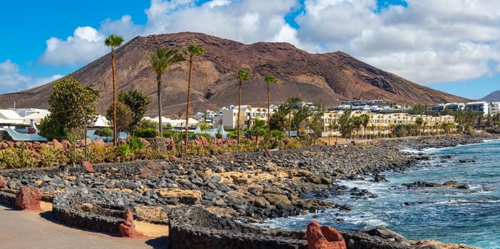 View of the vacation region on Playa Blanca with volcanic landscape in the background