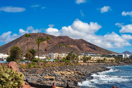View of the vacation region on Playa Blanca with volcanic landscape in the background