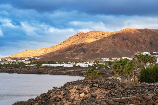 View of the vacation region on Playa Blanca with volcanic landscape in the background