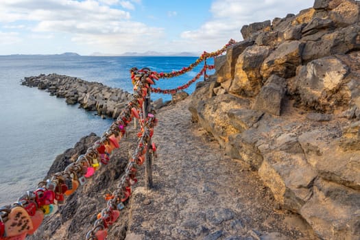 Many red heart-shaped love locks on the Playa Blanca on Lanzarote at the Playa Flamingo beach
