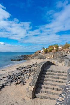 Steps from the promenade down to the beach at Playa Blanca with a view of the Atlantic Ocean on Lanzarote