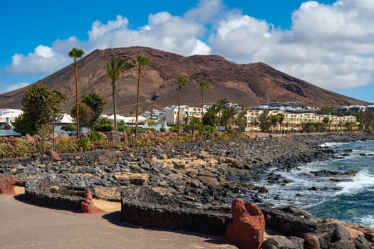 View of the vacation region on Playa Blanca with volcanic landscape in the background