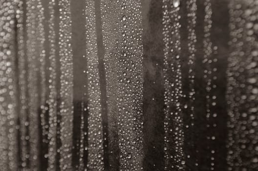 Rain droplets on dark background suitable for wallpaper decoration or design. Water droplets concept.