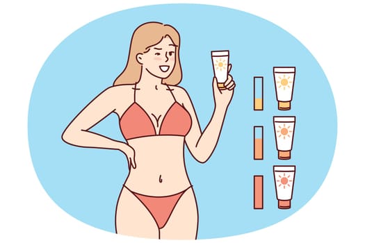 Woman in beach tanning bikini demonstrates anti-sunburn cream. Girl recommends purchasing high-quality tanning cream that promotes appearance of uniform skin tone when visiting solarium