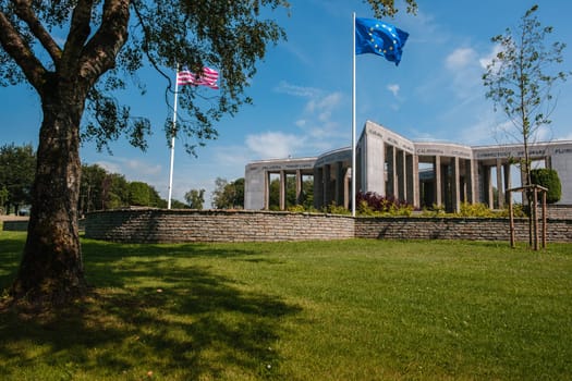 Bastogne, Luxembourg, Belgium - JULY 17, 2021: Mardasson Mermorial remembering Battle of the Bulge. American & EU flags in the foreground
