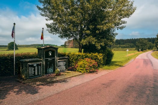 Foy (Bastogne), Belgium - July 17 2021: Battle of the Bulge Memorial E Company, 506th Infantry Regiment, 101st airborne division - road leading to the Bois Jacques in the background