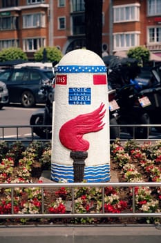 Bastogne, Belgium - July 17 2021: Milestone of the Voie de la Liberte 1944 (Liberty Road) on Mc Auliffe square in Bastogne. The Liberty Road is the commemorative way marking the route of the Allied forces starting on D-Day from Sainte-Mère-Église to end in Bastogne
