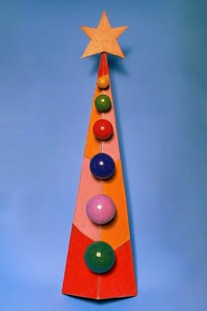 A stylized Christmas tree features a star on top, adorned with colorful ornaments arranged in a visually appealing design.