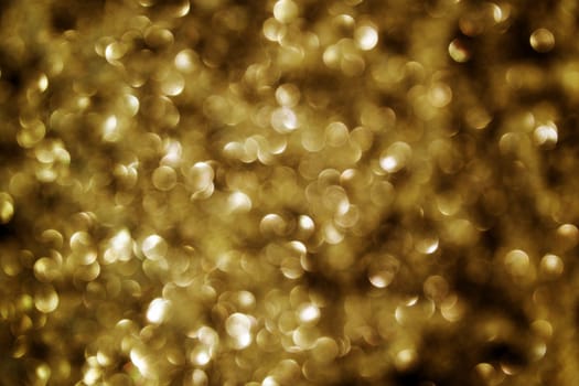 Golden and black background with dots of light